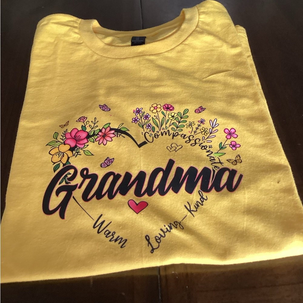 Custom made T Shirt that says Grandma with heart shaped flowers around “Grandma